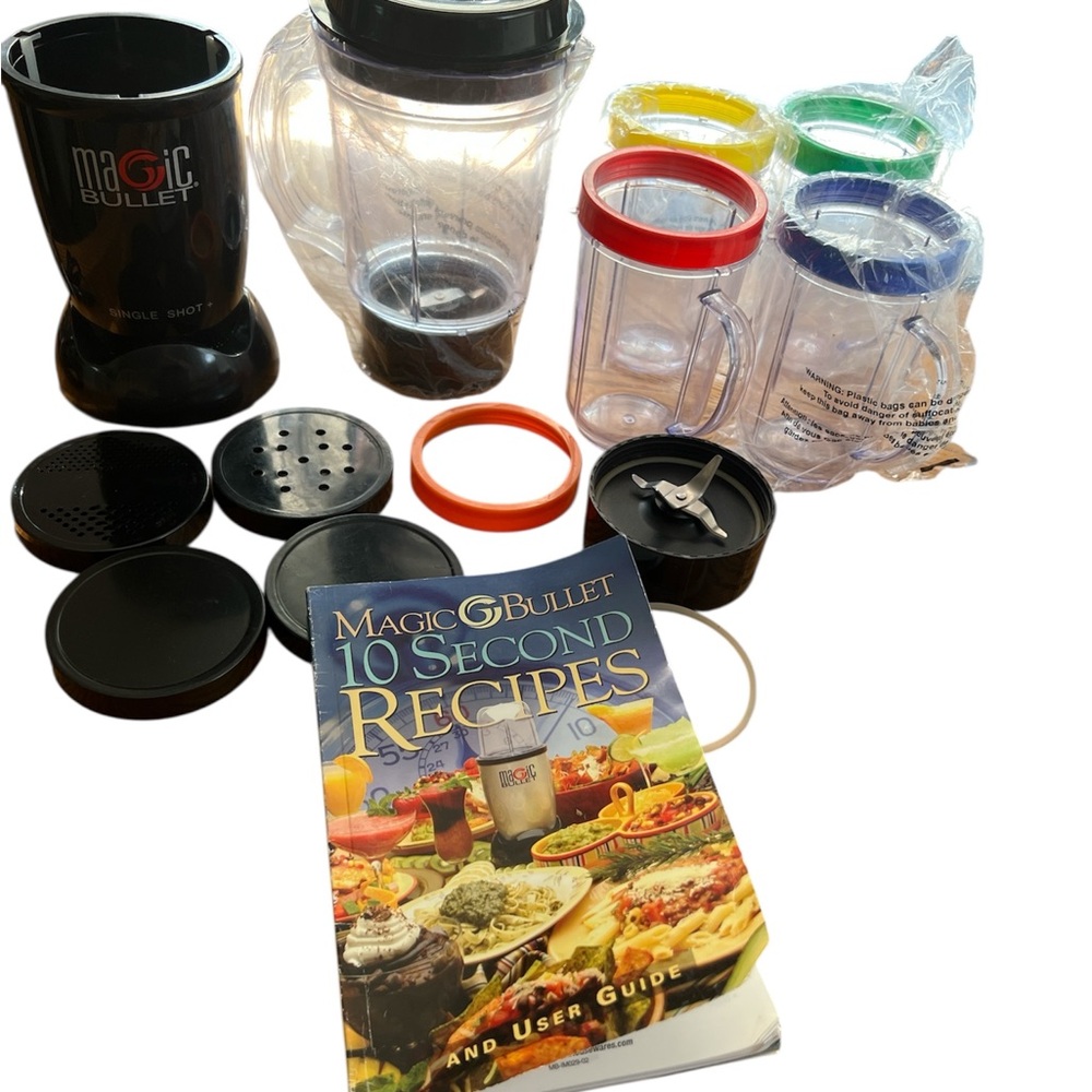 Magic bullet set with cookbook and carrying case. Blender top, 4 cups and more!